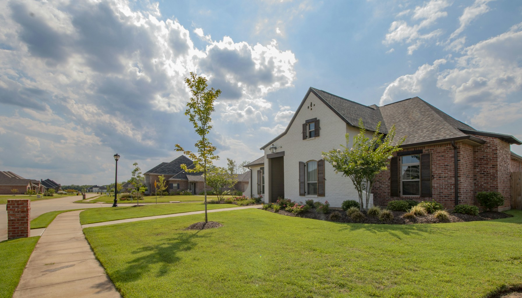 Build to rent investing — a modern planned community with single-family rental homes and manicured landscaping