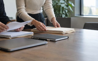 Founder and adviser organizing company records before a Reg CF background checks review