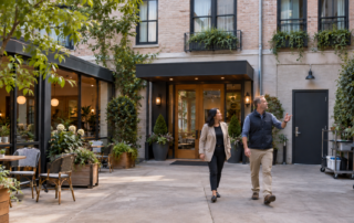 Hotel owner and facilities manager inspect an independent hospitality property before a capital planning decision
